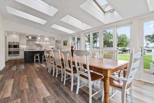 Whole house remodel near the Lake Geneva Yacht Club with skylit kitchen and long farmhouse dining table facing the lake